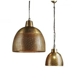 two brass colored pendant lights hanging from chains