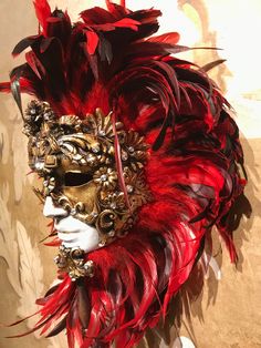 This masquerade mask for man and woman belongs to our collection of feathers' masks. These masks have a crown of red and black feathers. It is perfect for decoration or any masquerade party, Halloween costume, pro or event in Venice or elsewhere during Carnival. This mask can be gently bent to form to your face and ties in the back with two soft matching ribbons. Since the mask is handmade, your mask could be lightly different from the one in the picture. This mask is made on paper mache,decorat Red Fantasy Style Masks And Prosthetics For Events, Red Fantasy Masks And Prosthetics For Events, Red Fantasy Style Masks And Prosthetics For Fantasy Events, Red Fantasy Masks And Prosthetics For Fantasy Events, Artistic Red Masks And Prosthetics For Costume, Artistic Red Mask For Costume, Artistic Red Masquerade Mask For Mardi Gras, Artistic Red Masks And Prosthetics For Mardi Gras, Artistic Red Masks And Prosthetics For Theater