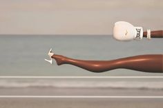 a woman's legs and leg with white shoes are shown in front of the ocean