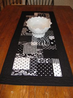 a black and white table runner with a bowl on it