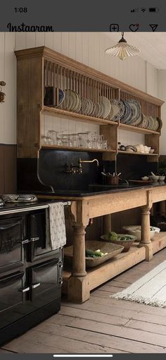 an old fashioned kitchen with many plates on the counter