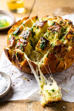 a cheesy bread dish with broccoli and cheese being lifted from it