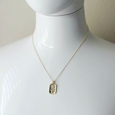 "Beautiful and lovely gold flower rectangle pendant necklace. Made of gold plated flower rectangle pendant with a skinny gold plated brass chain. Soft and simple. Great for gift, everyday or special occasion. Your item will ship in a gift box. Please feel free to contact me if you have any questions. ♥ Length 15\" - 22\" chain ♥ Pendant 1/2\" x 1\" ♥ Gold plated over brass ♥ See more Rudiana Accessories Rudiana.etsy.com" Gold Plated Charm Necklace With Rectangular Pendant, Gold Rectangular Charm Necklace Gift, Gold Charm Necklace With Rectangular Pendant For Gift, Gold Rectangular Jewelry With Birth Flower, Gold Oblong Necklace For Gift, Gold Rectangular Birth Flower Jewelry, Dainty Gold-plated Charm Necklace With Rectangular Pendant, Gold Rectangular Charm Necklace For Mother's Day, Delicate Chain Charm Necklace With Rectangular Pendant For Gift