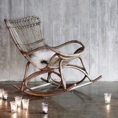 a rocking chair with candles in front of it