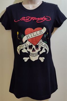 Ed Hardy black short sleeve t-shirt that has the name logo embroidered in red. This t-shirt is very unique and hard to come by, truly a rare find. Please view all photos provided as they are part of this item's description. Measurements are, armpit-armpit:17", top-bottom: 26", sleeves: 5". T-shirt is made of 100% cotton. Any questions please ask. This item will be shipped mostly the same day of purchase by USPS Priority Mail. Please note that the price of this item reflects on the shipping costs Fitted Black Top With Embroidered Logo, Fitted T-shirt With Embroidered Text And Short Sleeve, Fitted Black Embroidered T-shirt, Red Short Sleeve Top With Embroidered Graphics, Red Short Sleeve T-shirt With Embroidered Text, Red Embroidered Graphic Tee T-shirt, Red Embroidered Graphic Tee, Black Embroidered T-shirt, Ed Hardy Shirt