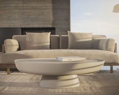 a white bowl sitting on top of a wooden floor next to a couch and table