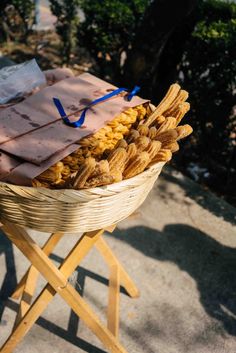 a basket filled with lots of food sitting on top of a wooden stand