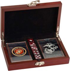 two dice sets in a wooden box with metal handles and emblems on the sides