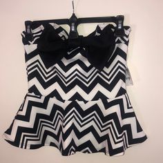 This Polyester/Spandex Blend Top Is Strapless, With A Semi-Sweetheart Neckline. The Adorable Black Bow Takes Center Stage And Compliments The Black And White Geometric Pattern Of The Whole Thing. Nwt Trendy White Tube Top For Party, Fitted Black And White Tops For Party, Fitted Black And White Party Tops, Strapless Peplum Top, Black And White Geometric Pattern, Tan Tank Top, White Crop Top Tank, Sequin Shirt, Crochet Tank Top