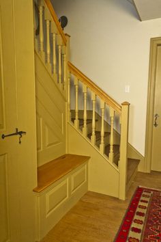 the stairs are made of wood and have handrails