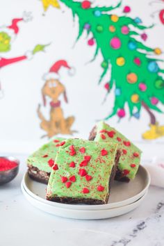 there are pieces of cake on the plate and one is green with red sprinkles