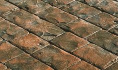 an old brick sidewalk with the words london cobble written in white letters on it