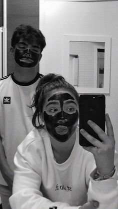 two people with face masks on taking a selfie