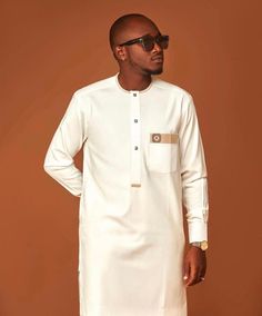 Made from original kaftan material , carefully handmade with love 💗 , brings out the African Royal feelings in you White Long Sleeve Thobe For Formal Occasions, Formal White Long Sleeve Thobe, Elegant White Long Sleeve Agbada, Elegant Long Sleeve Kurta For Traditional Ceremonies, White Long Sleeve Agbada For Traditional Ceremonies, Elegant Agbada For Eid Ceremony, Elegant Cream Kurta For Traditional Ceremonies, Elegant White Kurta For Ceremony, Elegant Fitted Ceremonial Thobe