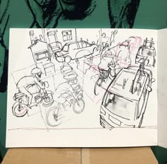 a drawing is shown on top of a cardboard box in front of a green wall