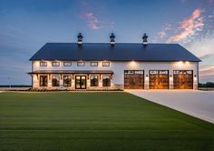 a large white house sitting on top of a lush green field