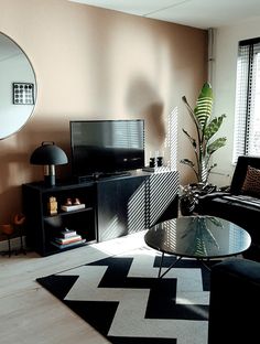 a living room filled with furniture and a flat screen tv on top of a stand