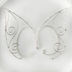 Intricate wire elf ears. Adjustable fitting that wraps around your ear. Very lightweight and secure fit. Comes in a pair.  DETAILS - comes in a pair - overall length is 3.5 inches - adjustable fit - lightweight and easy to wear - nickel and lead free - securely packaged in a signature gift box Wire Elf Ears, Ear Wraps, Elf Ear, Elf Ear Cuff, Elf Ears, Wrap Earrings, Ear Cuffs, Hand Art Drawing, Savannah Ga