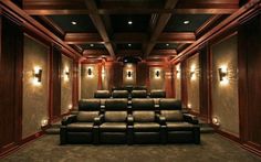 an empty theater with leather recliners and lights