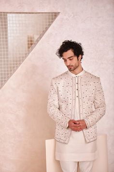 Featuring kashmiri jamawar hand embroidered short jacket. Paired with short kurta and tapered trousers. Off White Bandhgala With Naqshi For Festive Occasions, Off White Naqshi Bandhgala For Festive Occasions, Designer Nehru Jacket In Off White, Fitted Off White Nehru Jacket For Designer Wear, Designer Off-white Fitted Nehru Jacket, Fitted Off-white Nehru Jacket For Designer Wear, Bollywood Style Off White Bandhgala With Naqshi, Fitted Off White Nehru Jacket With Chikankari Embroidery, Fitted Off-white Nehru Jacket With Chikankari Embroidery