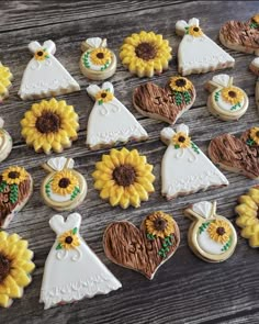 sunflower decorated wedding cookies arranged on a wooden table with white dress and sunflowers