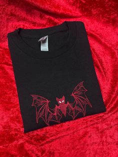 Bat Embroidered T-Shirt! If you have any questions please feel free to send me a message!  🖤HOW TO ORDER: - Please choose sweatshirt COLOUR and SIZE from the drop down menu, then please put what thread colour you would like in the personalisation box! 🖤MATERIAL: - We use Gildan Ultra Cotton as our blanks which are 100% cotton. Apart from ASH which is 99/1 Cotton and Polyester 🖤SIZES: - Please check size guide before you order. Sizes Small to 5XL in BLACK, WHITE AND GREY! PINK goes up to 2XL ? Embroidered Tee, Embroidered Tshirt, Halloween T Shirt, Halloween Tshirts, Send Me A Message, The Drop, The Door, Just In Case, Machine Embroidery