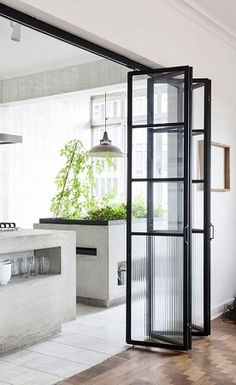 an open kitchen and living room with sliding glass doors