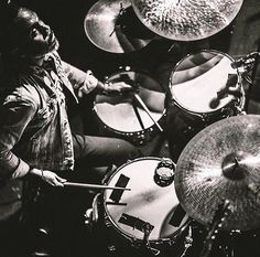 black and white photograph of drummer playing drums