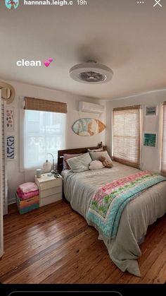 a bed room with a neatly made bed and wooden floors