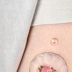 a close up of a person's stomach with a flower on it