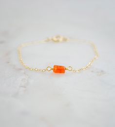 Add some color to your wardrobe with Carnelian! This bracelet features a handmade, smooth polished Carnelian gemstone set onto a sterling silver or 14k gold filled chain. Most stones have natural banding in shades of dark and light orange, as well as some clear areas. Carnelian Meaning: Carnelian is a type of orange Chalcedony quartz that is believed to enhance passion, love, and desire. It is a high energy crystal said to inspire confidence, prosperity, and good luck.Stone Size: Average 6 to 8mm (.24 x .31") Carnelian Meaning, Types Of Oranges, Carnelian Bracelet, Energy Crystals, High Energy, Light Orange, Gold Filled Chain, Gemstone Bracelet, Ring Necklace