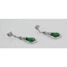 This is part of Chairish’s Fine Jewelry assortment.  Jade Enamel Diamond Long Earrings  These beautiful Jade Enamel Diamond long drop earrings consist of a teardrop Jade surrounded by Diamonds and green (same color as the Jade) Enamel. These earrings come from Spain and weight 16.2 grams. They are 5.3mm wide and 2 1/2" long. In beautiful condition. I love long drop earrings as I have long hair and when worn they show, but short haired women would like these as well because they make a bold state Elegant Jade Dangle Earrings, Pierced Jade Dangle Earrings, Traditional Jade Drop Earrings, Silver Jade Dangle Earrings, Luxury Silver Jade Earrings, Long Drop Earrings, Long Earrings, Jade, Fine Jewelry