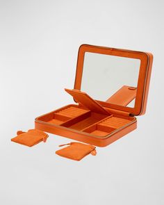 an orange suitcase with four pieces in it and one piece missing from the inside is open