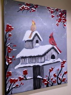 a painting of two birds sitting on top of a bird house in the snow with red flowers