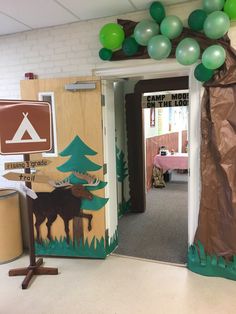 an entrance to a camp room decorated with balloons