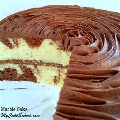 a close up of a cake with chocolate frosting on the top and one slice missing