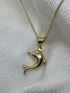 "ABOUT PRODUCT This 14K solid gold Dolphin Pendant necklace is beautifully designed and hand crafted with our associates to make this a special gift for your loved ones. Knowing the value of our customers, We prepare each piece with extra care and attention.  ITEM DETAILS Material: 14K Gold Approx:  1.35 gram Available colors: Gold, Rose Gold, White Gold Available Sizes: 14\" to 20\" ✪ 14k Solid Gold ( Certification will be included with your order ) ✪Available 14K White, Yellow, Rose Gold (also Ocean-inspired Gold Necklaces For Vacation, Gold Ocean-inspired Pendant Jewelry, Elegant Yellow Gold Fish Shaped Necklace, Gold Fish-shaped Necklace For Gift, Elegant 14k Gold Fish-shaped Jewelry, Dolphin Fish, Dolphin Necklace Pendants, Dolphin Pendant, Dolphin Necklace