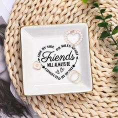 a white plate sitting on top of a table next to a plant and some pictures