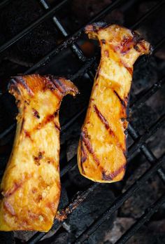 two grilled meats sitting on top of a grill with the words king oyster mushroom steak