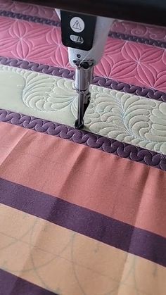 a close up of a sewing machine on a quilt