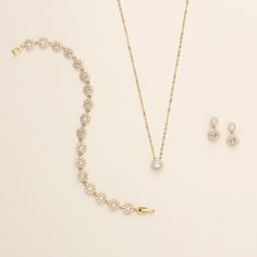 "This sparkling round halo gold wedding jewelry set will surely add brilliance to your special day! This earrings and necklace set is perfectly matched with clear AAA grade prong set cubic zirconia in a single round framed design. Perfect for the bride or makes a great bridesmaid jewelry gift!   DETAILS * High quality cubic zirconia.  * Earrings measure 1/2 inches. (pierced or clip-ons) * Necklace is adjustable from 16 inches to 18 inches long, pendant measures 8mm. * Perfect for brides, bridesm Gold Jewelry With Sparkling Stones, Round Crystal Jewelry Set For Anniversary, Gold Crystal Jewelry Sets, Gold Crystal Sparkling Jewelry Sets, Gold Cubic Zirconia Round Bridal Sets, Gold Jewelry Sets With Brilliant Cut For Gifts, Elegant Gold Bridal Sets With Halo Setting, Crystal Jewelry With Halo Setting For Wedding, Wedding Crystal Jewelry With Halo Setting