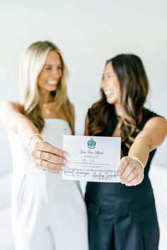 two beautiful women holding up a cheque check