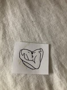 a piece of paper with a drawing of a dog's head hanging from it