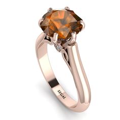 a ring with an orange diamond in the center