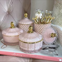 pink and gold bathroom accessories are on display