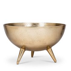 a gold bowl with wooden legs on a white background