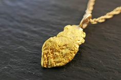 Small, all natural & real real gold nugget pendant.  Unique nugget pendant with a rustic character. Great gift for all lovers of Nature's creations and the Great Outdoors, and for a special person in your life.  Wear it layered with other necklaces, or as a single highlight. > all natural gold nugget, just as it was mined in the province of British Columbia/ Canada > overall approx. 21mm (0.82 inches) long pendant > pendant weight is 2.39 grams > gold filled chain in the length of your choice  T Gold Nugget Jewelry, Natural Gold Nugget, Nugget Necklace, Real Real, Unique Gifts For Men, Gold Nugget, Natural Gold, British Columbia Canada, Gold Rush