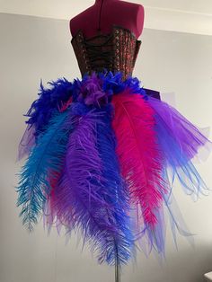 a mannequin with colorful feathers on it