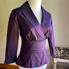 Deep eggplant purple with a gorgeous iridescent sheen. Deep v neckline with shawl collar, 3/4 sleeves with slits, back zip DOWN from just below the collar. Wide attached ties at the pe plated waist. Looks, feels and sounds like silk taffeta, but is 62/32/6 rayon/poly/lycra. The Lycra adds a nice amount of stretch for a flattering fit. By Tadashi, made in USA and tagged a size 4.   Please use the measurements for fit.   Taken flat Pit to pit 16"  Shoulder 15"  Sleeve from shoulder seam 19"  Length from collar seam 21"  Because sizing is not universal among makers or across decades, size numbers are just a starting point. To ensure proper fit, you must measure and compare to a garment that fits you well. There really is no other way. Please be aware, if you need an exact color match, that co Purple V-neck Top For Evening, Purple V-neck Blouse For Formal Occasions, Formal Fitted V-neck Tops, Purple Silk Formal Blouse, Fitted Purple Blouse For Party, Purple Long Sleeve Evening Blouse, Formal Purple Silk Blouse, Fitted V-neck Blouse For Evening, Fitted Purple Blouse For Evening