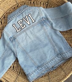 Hi there! Welcome to my shop. This listing is for the varsity font. These unisex personalized embroidered denim jacket are available in toddler and children's sizes. These Custom denim jacket makes the best birthday or baby shower gift!  Jacket is light wash and has a slightly oversized fit. Because these are one of a kind, returns are not accepted. Each item is made to order and hand embroidered by me so slight variations may occur. I am unable to replace/refund purchases based on color and fon Boys Denim Jacket, Varsity Font, Kids Jeans Jacket, Custom Denim Jacket, Toddler Gift, Embroidered Denim Jacket, Custom Denim, Boys Denim, Yarn Projects